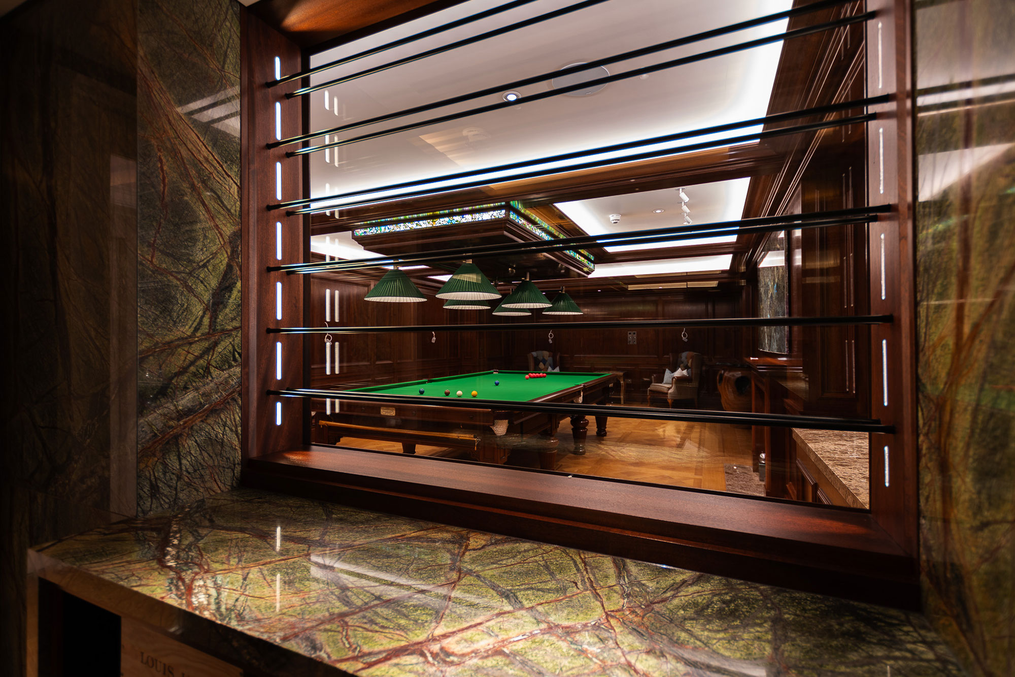 Window recess into traditionally panelled entertainment space and games room in a London home by William Garvey Bespoke furniture maker and designer