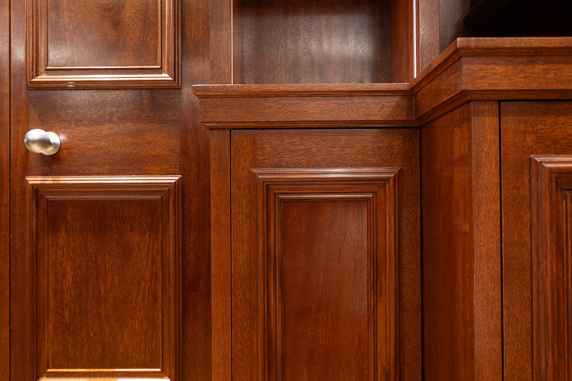 Traditional panelling in african mahoghany for an entertainment space and games room in a London home by William Garvey Bespoke furniture maker and designer