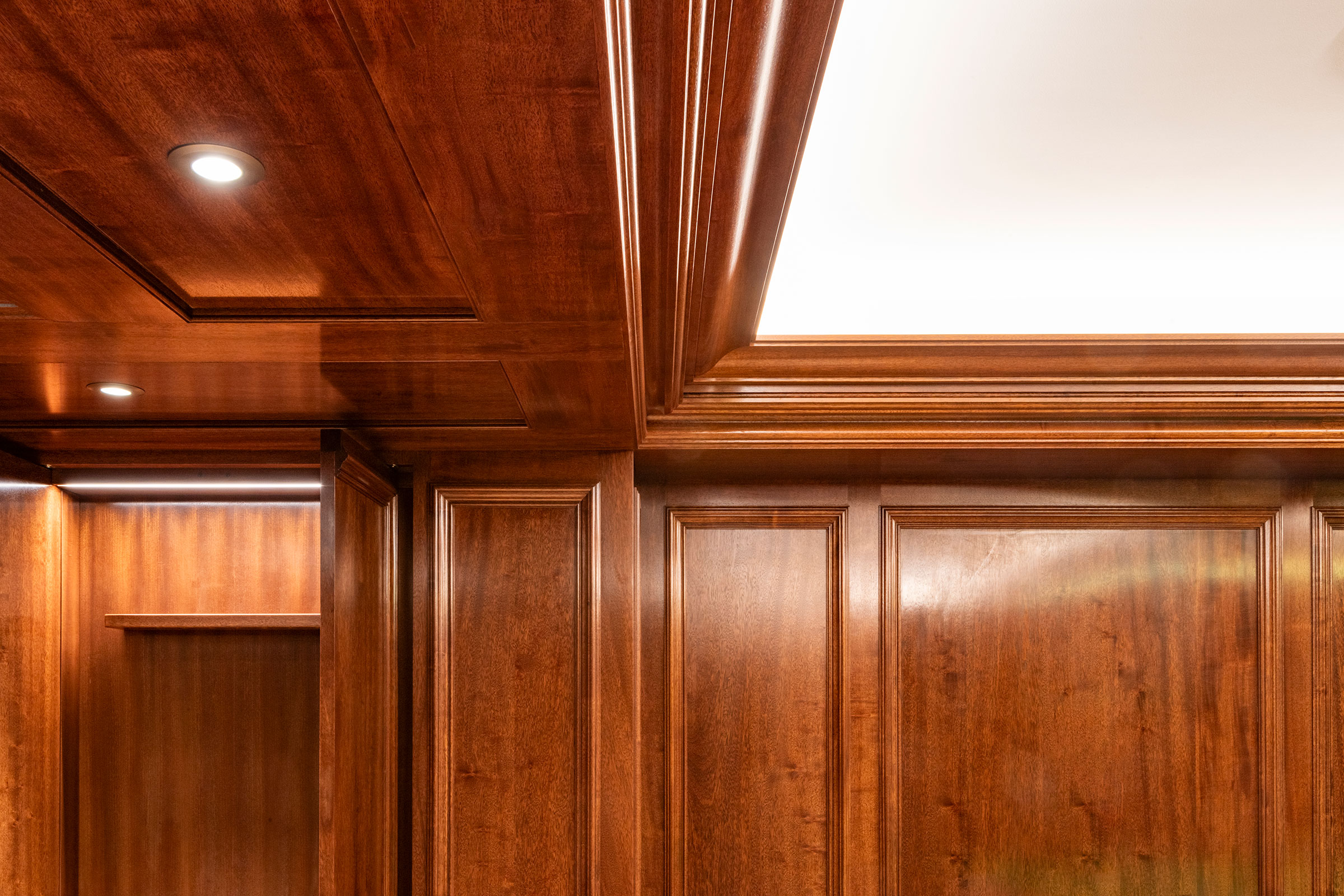 Traditional panelling in african mahoghany for an entertainment space and games room in a London home by William Garvey Bespoke furniture maker and designer