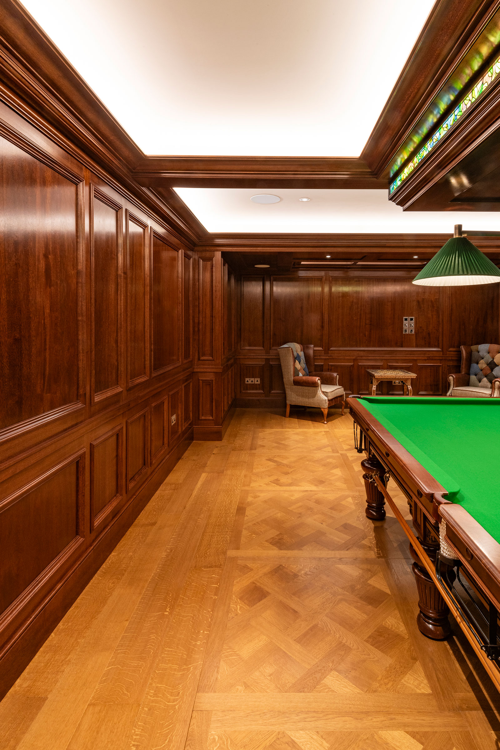 Traditional panelling in african mahoghany for an entertainment space and games room in a London home by William Garvey Bespoke furniture maker and designer