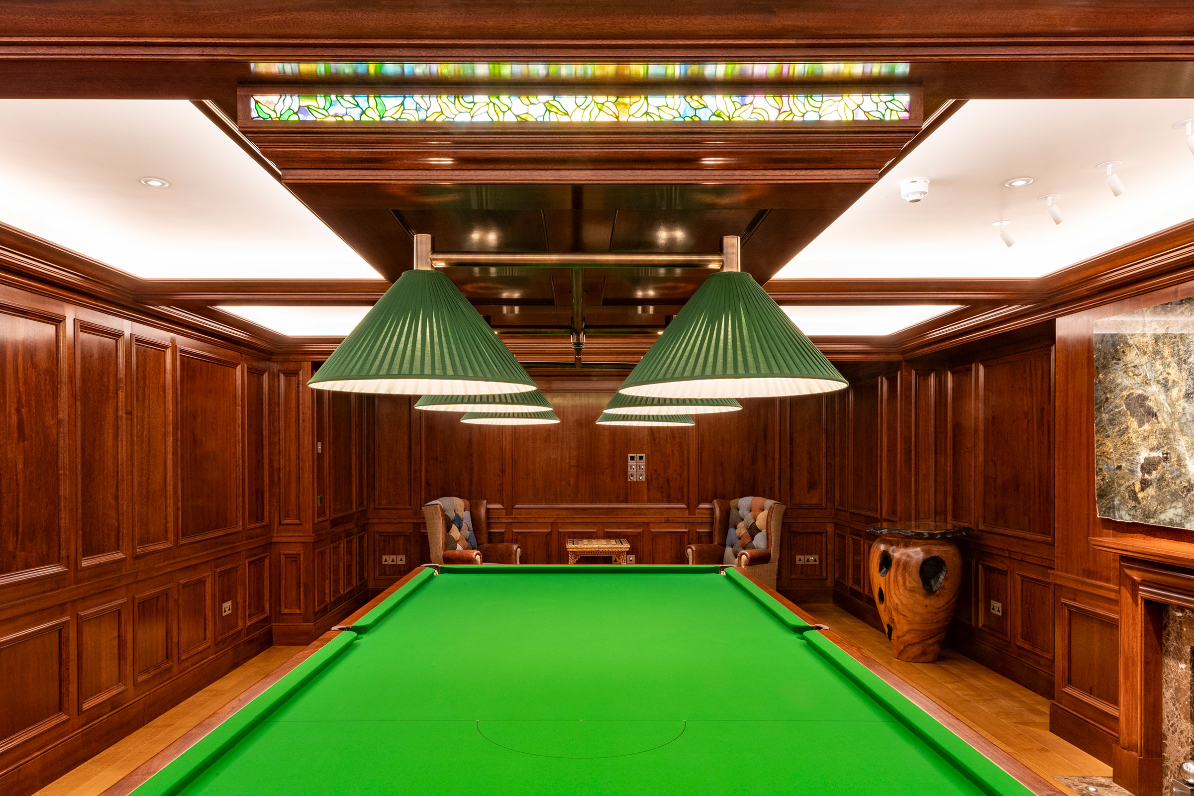 Traditional panelling and ceiling in african mahoghany for an entertainment space and games room in a London home by William Garvey Bespoke furniture maker and designer