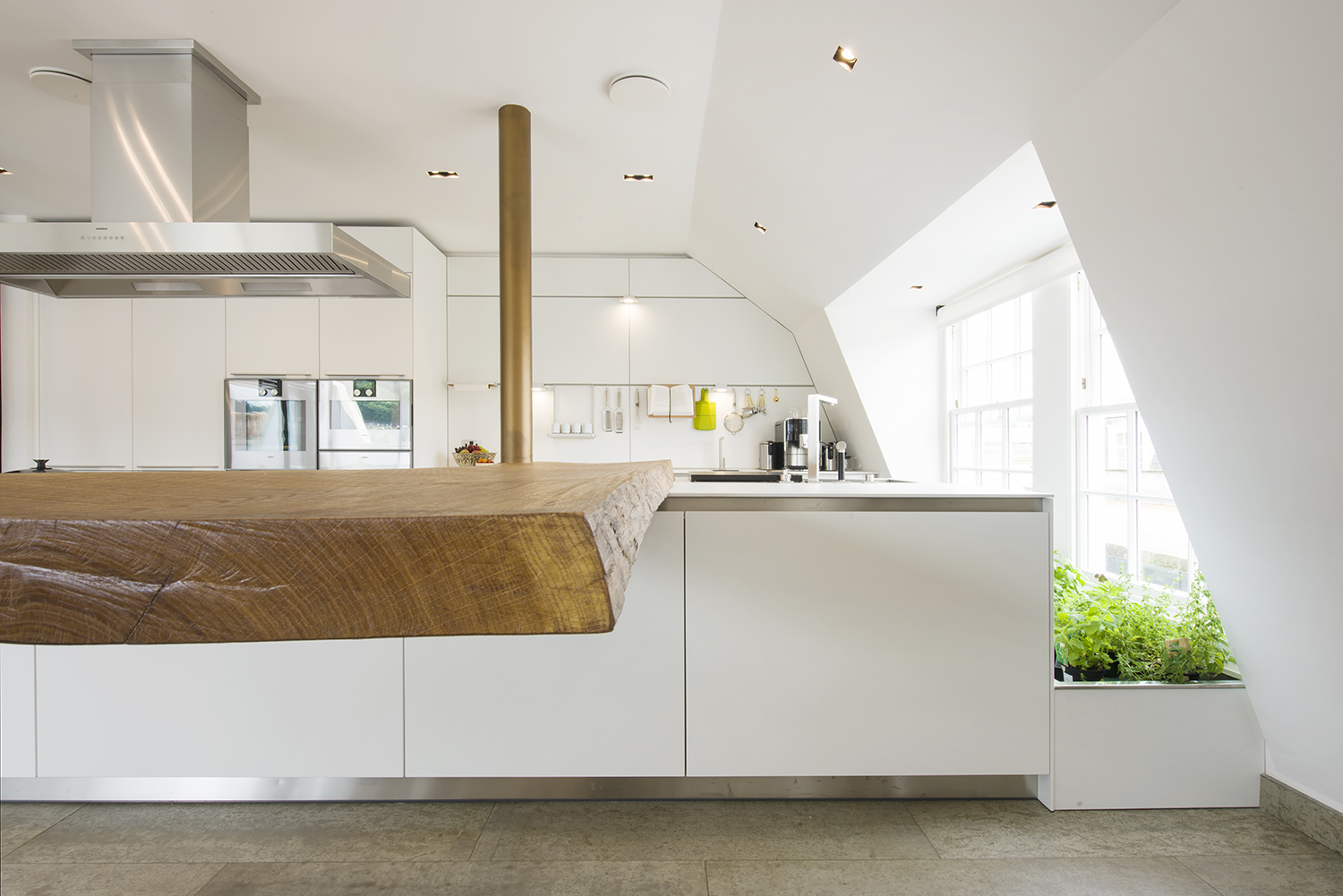 Bespoke kitchen island in waney edge oak, bedroom joinery and furniture for a penthouse in bath all by William Garvey furniture designers and makers