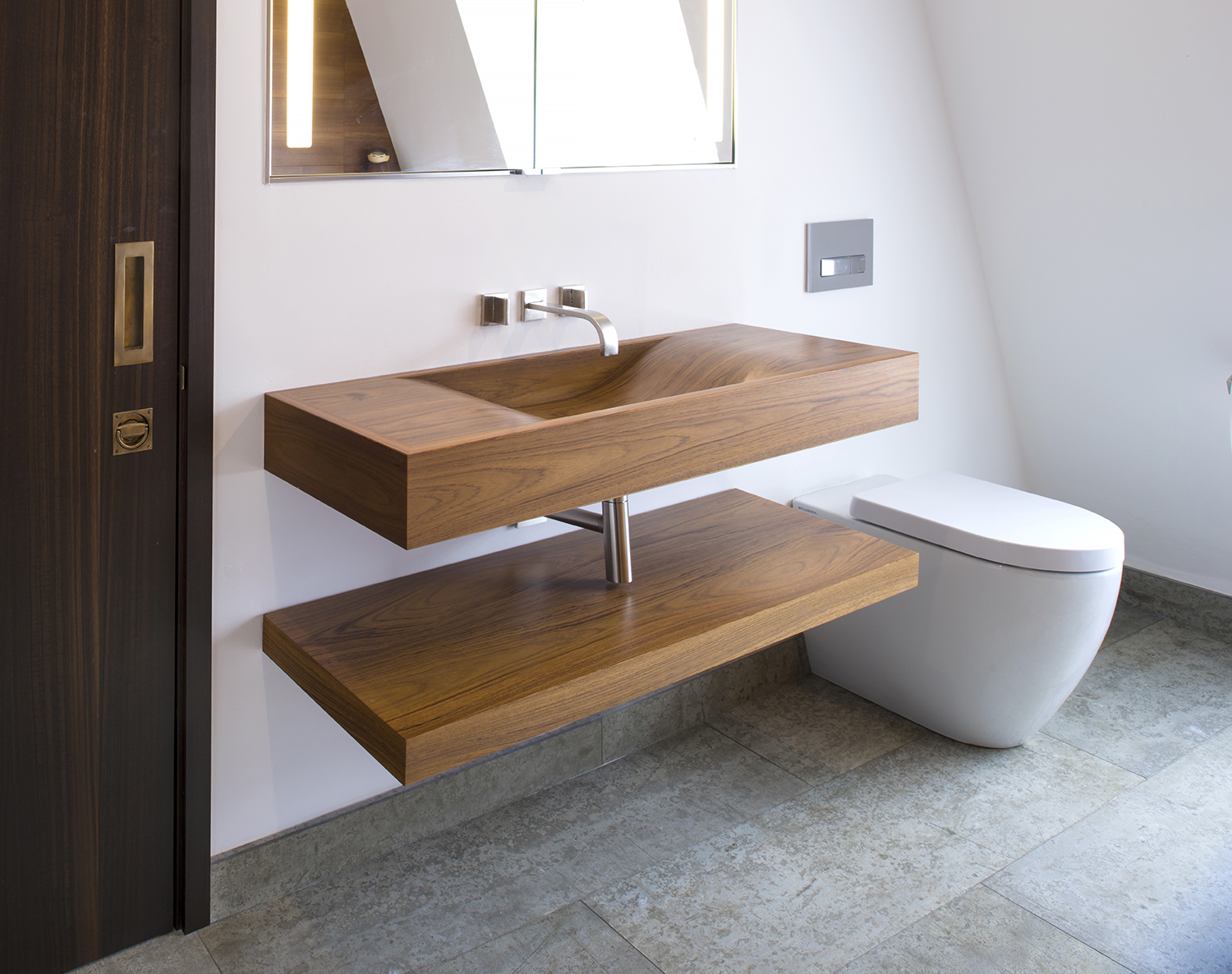 Bespoke waterproof teak sink and floating shelf for a penthouse in bath all by William Garvey furniture designers and makers