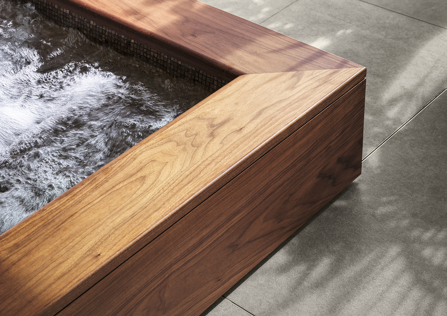 Bespoke jacuzzi surround in walnut in the wellness suite of a listed manor house in Somerset - all bespoke joinery and furniture by William Garvey British furniture designers and makers