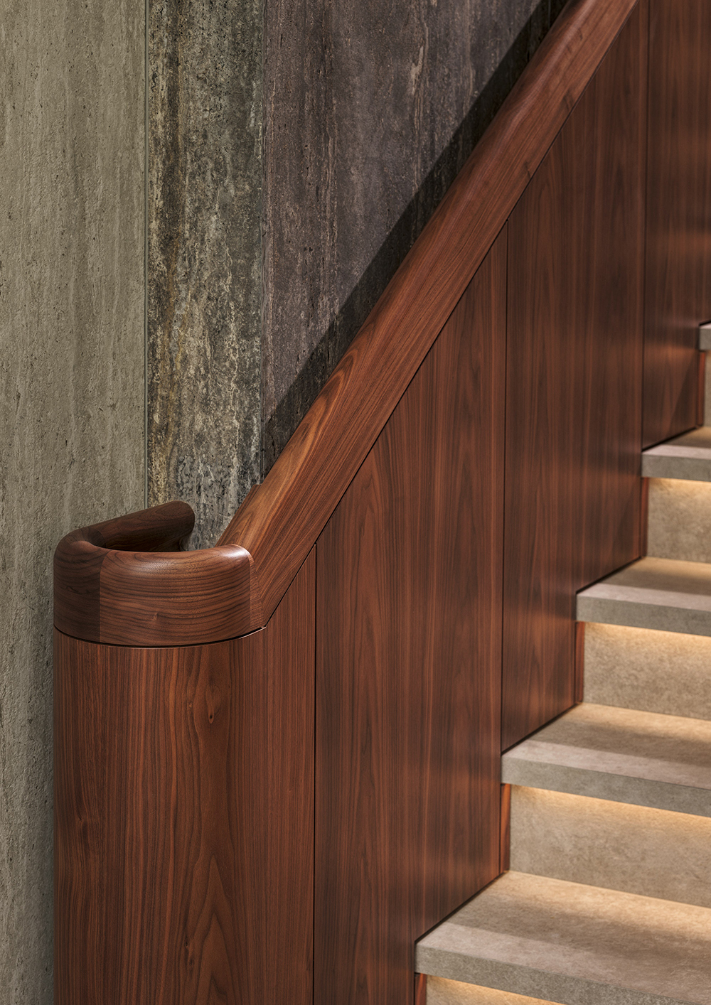 Bespoke curved solid walnut handrail and flamed walnut panelled staircase in the modern extension of a listed manor house in Somerset - all bespoke joinery and furniture by William Garvey British furniture designers and makers