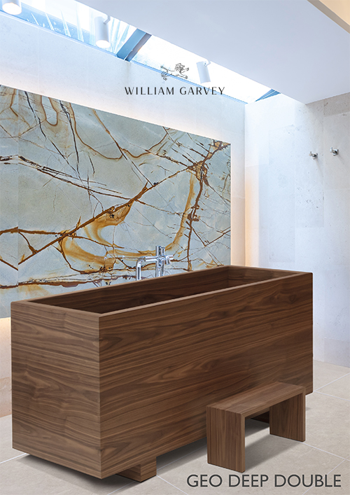 A waterproof wooden bath by William Garvey placed in front of a stunning quartzite stone. William Garvey waterproof wood Geo Deep Double Bath data sheet literature brochure